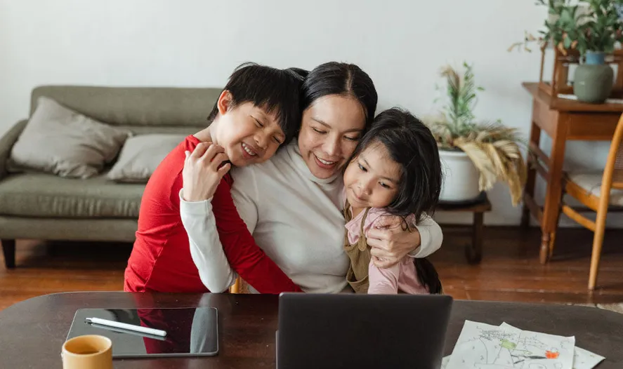 business mom balancing laptop and baby
